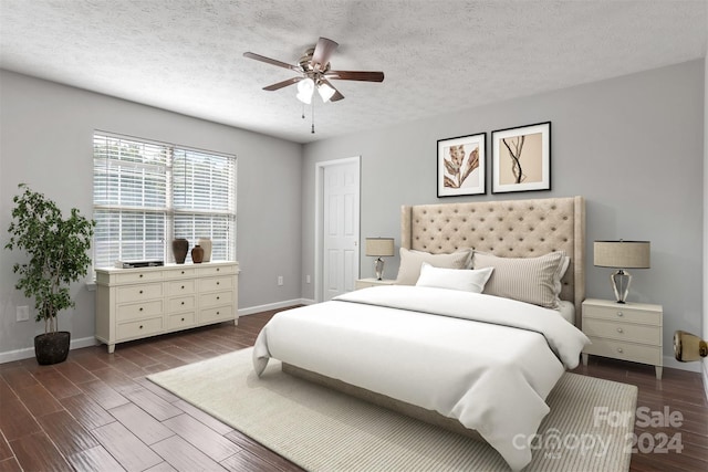 bedroom featuring ceiling fan, a textured ceiling, and dark hardwood / wood-style flooring