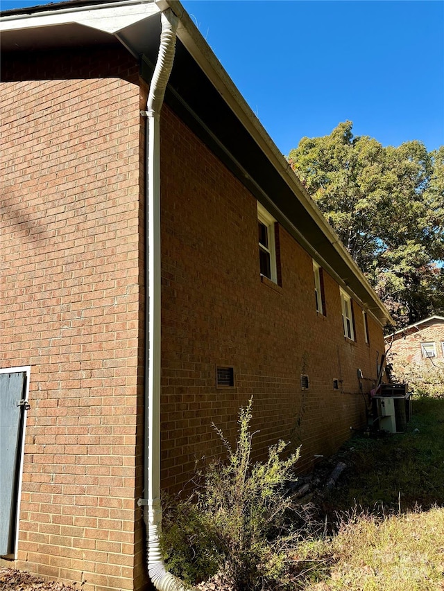 view of side of home with central air condition unit