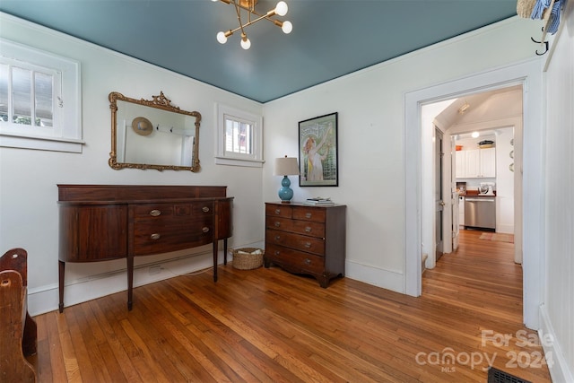 interior space featuring wood-type flooring and a notable chandelier