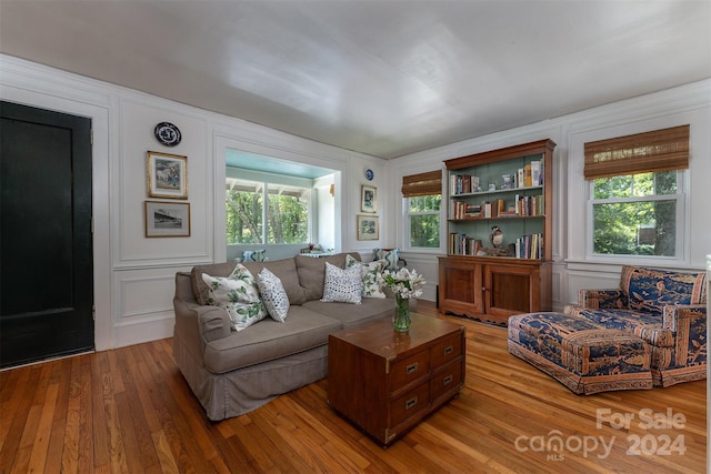 living room with plenty of natural light and light hardwood / wood-style flooring