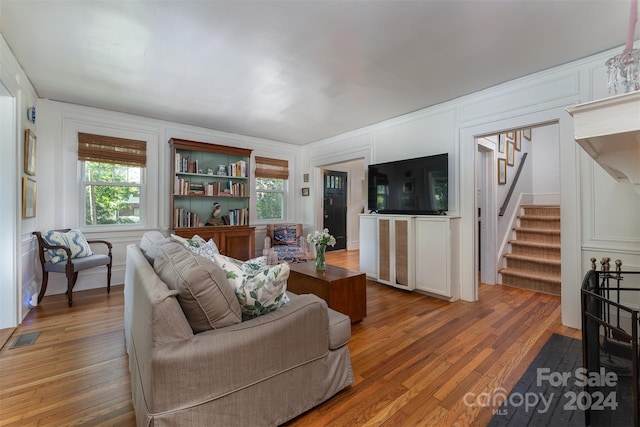 living room with a wealth of natural light and wood-type flooring