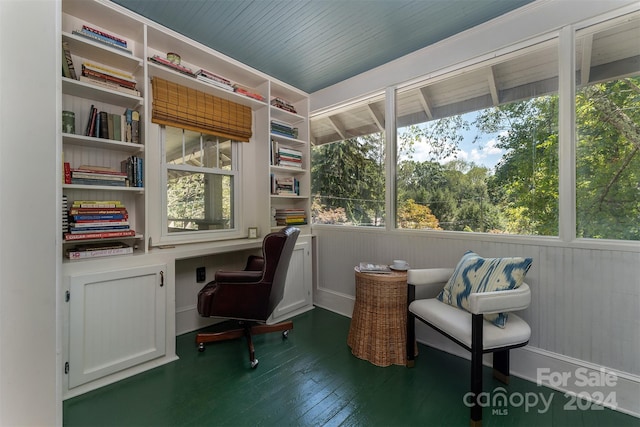 home office with wooden walls and dark hardwood / wood-style flooring