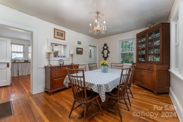 dining room featuring a chandelier and hardwood / wood-style floors