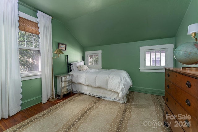 bedroom featuring hardwood / wood-style flooring and vaulted ceiling