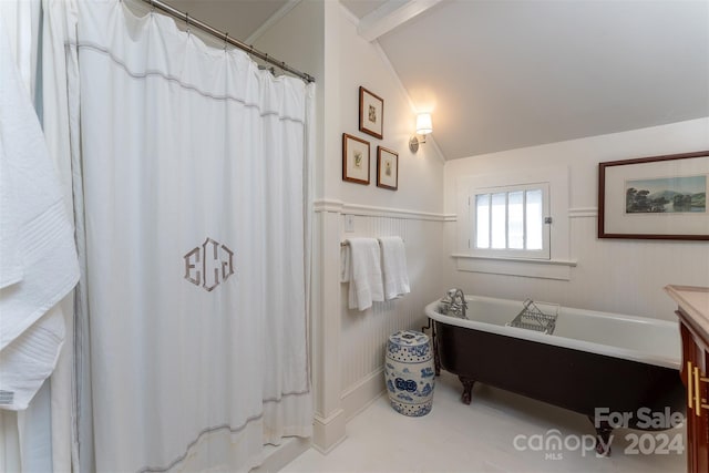 bathroom featuring a bath, vanity, and vaulted ceiling