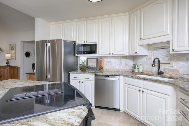 kitchen with white cabinets, light stone countertops, sink, and black appliances