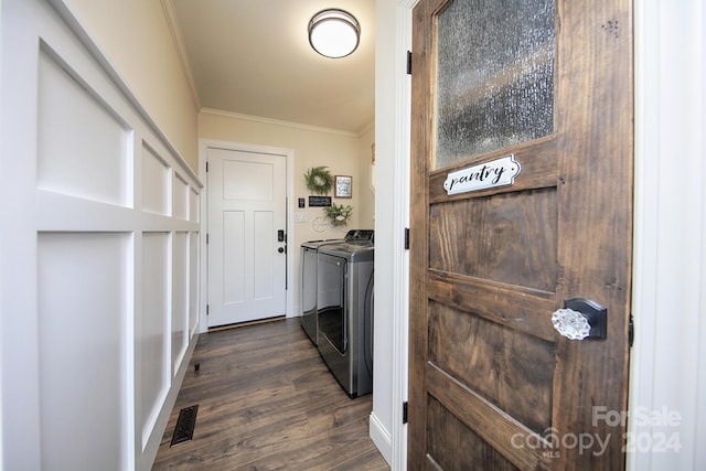 clothes washing area featuring ornamental molding, independent washer and dryer, and dark hardwood / wood-style flooring