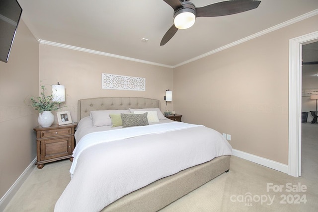 bedroom with light carpet, ceiling fan, and crown molding