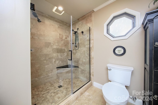 bathroom featuring ornamental molding, tile patterned flooring, toilet, and an enclosed shower