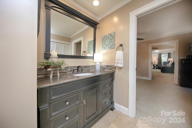 bathroom with vanity, backsplash, ornamental molding, and tile patterned flooring