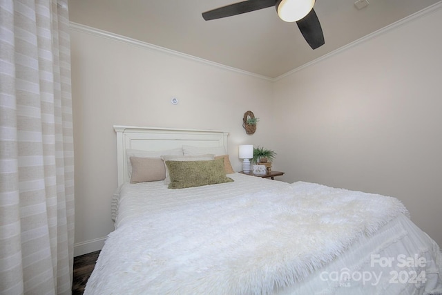 bedroom featuring wood-type flooring, ceiling fan, and crown molding