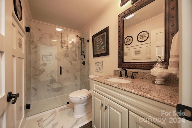 bathroom featuring crown molding, vanity, toilet, and a shower with shower door