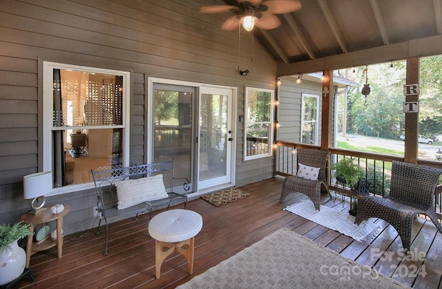 sunroom featuring lofted ceiling, ceiling fan, and plenty of natural light