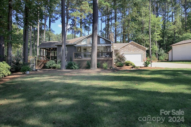 view of front of property featuring a porch, a garage, and a front yard