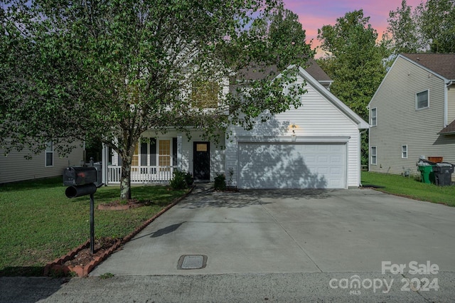 obstructed view of property with a porch and a yard