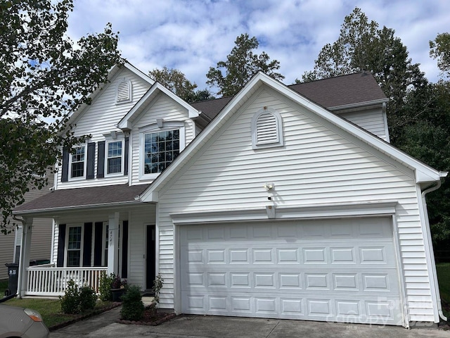 view of front property featuring a porch and a garage