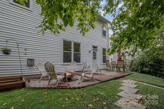 back of property featuring a patio area and a fire pit