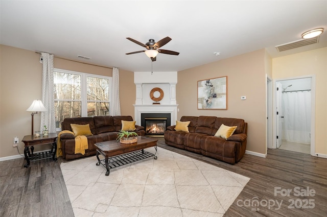 living room featuring ceiling fan and light hardwood / wood-style flooring