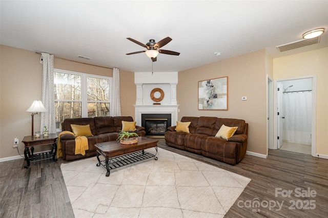 living room featuring light hardwood / wood-style floors and ceiling fan