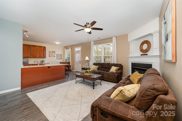 living room featuring ceiling fan and light hardwood / wood-style floors