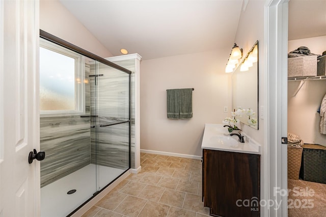 bathroom featuring tile patterned floors, vanity, and walk in shower