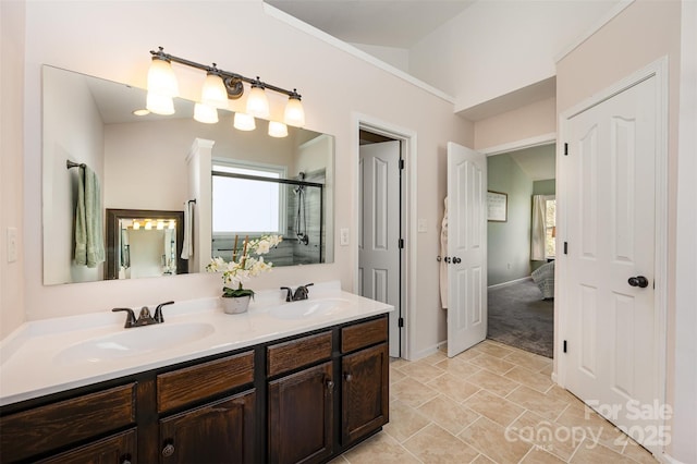 bathroom with a shower with shower door and vanity