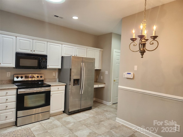 kitchen featuring light countertops, visible vents, appliances with stainless steel finishes, and a chandelier