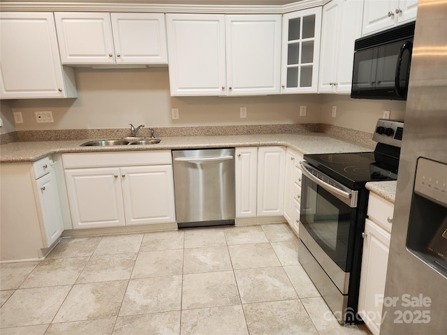 kitchen with light tile patterned floors, a sink, white cabinets, glass insert cabinets, and appliances with stainless steel finishes