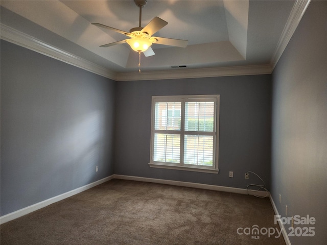 unfurnished room featuring visible vents, crown molding, baseboards, carpet, and a tray ceiling