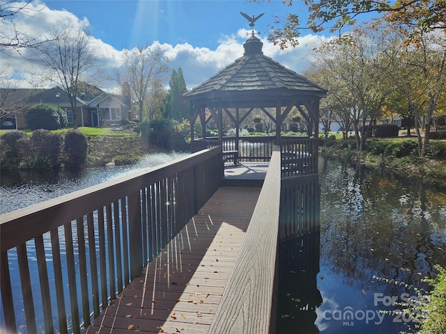 view of dock featuring a gazebo and a water view