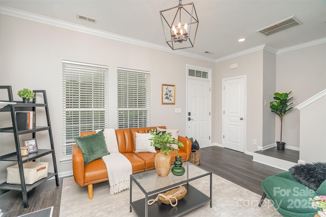 living room featuring wood-type flooring, crown molding, and a notable chandelier