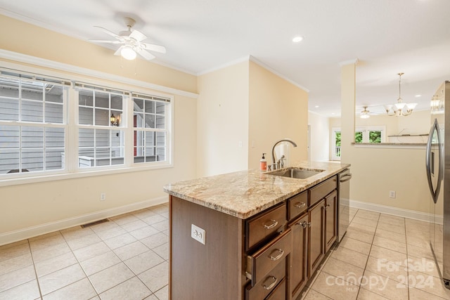 kitchen featuring sink, decorative light fixtures, a center island with sink, ceiling fan with notable chandelier, and crown molding