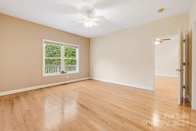 empty room featuring ceiling fan and light hardwood / wood-style floors