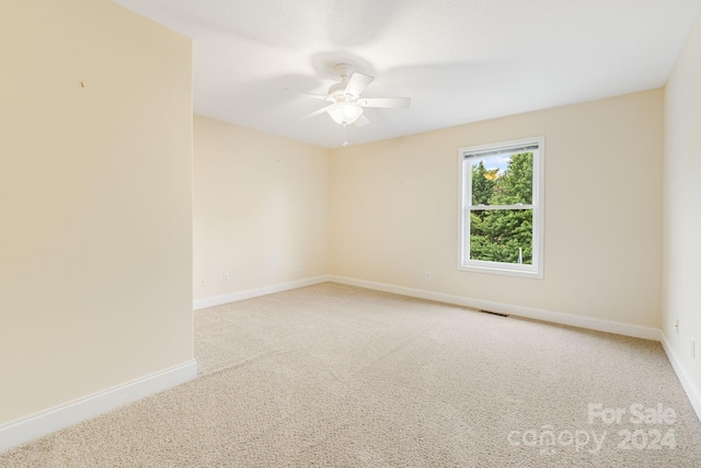 empty room with ceiling fan and carpet