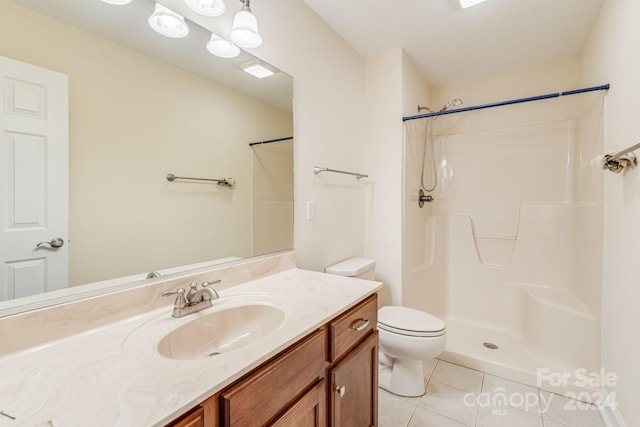 bathroom with walk in shower, vanity, toilet, and tile patterned floors