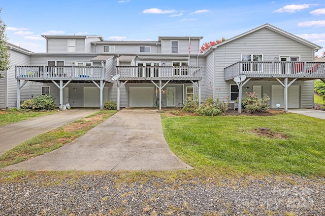 view of front of property with a front yard, a deck, and a garage