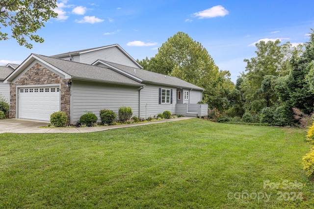 view of front of home with a front lawn and a garage