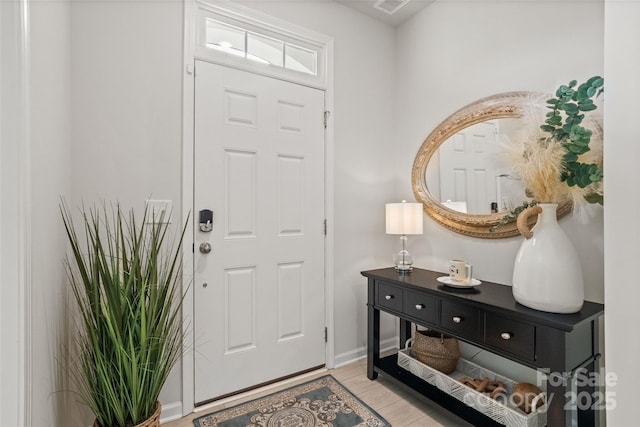 entryway with light hardwood / wood-style flooring