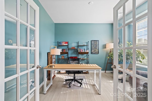 office space featuring french doors and hardwood / wood-style flooring