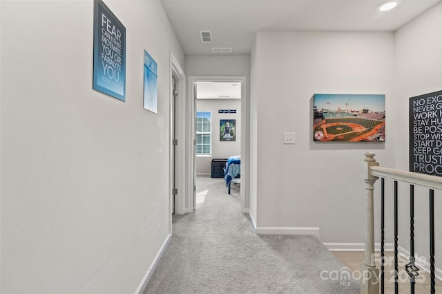 hallway with light colored carpet