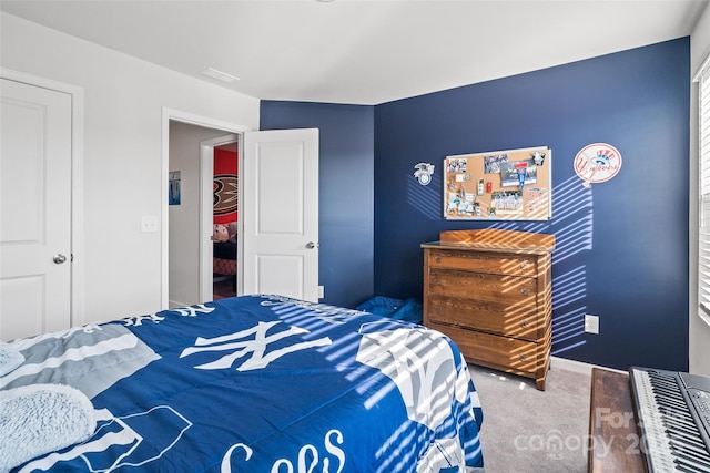 carpeted bedroom with a closet