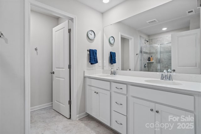 bathroom with vanity and a shower with shower door