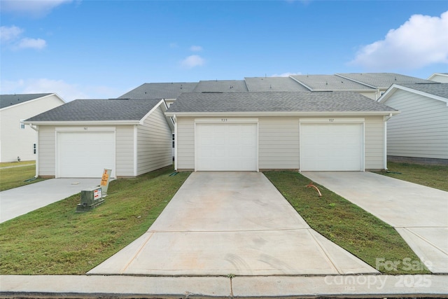 ranch-style house with a garage and a front lawn