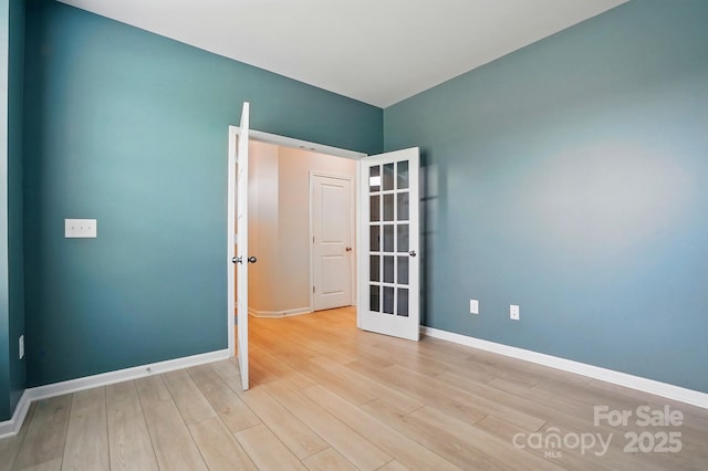 939 Cobbled Way, Fort Mill, SC 29715 - empty room featuring french doors, wood finished floors, and baseboards