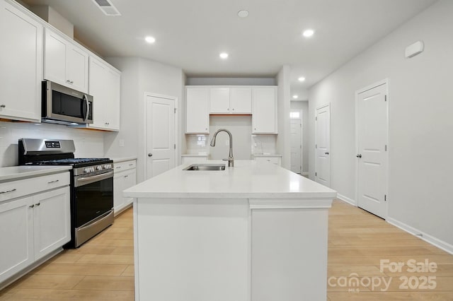 939 Cobbled Way, Fort Mill, SC 29715 - kitchen featuring stainless steel appliances, a sink, light wood-style floors, recessed lighting, and white cabinetry