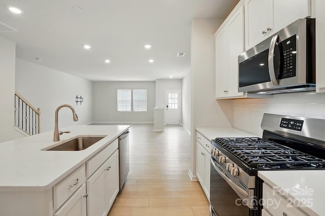 939 Cobbled Way, Fort Mill, SC 29715 - kitchen with appliances with stainless steel finishes, a sink, open floor plan, recessed lighting, and light countertops