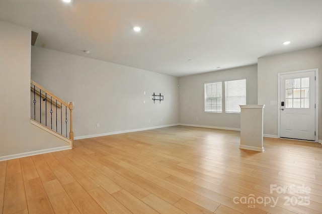 939 Cobbled Way, Fort Mill, SC 29715 - unfurnished living room with stairs, light wood-type flooring, baseboards, and recessed lighting