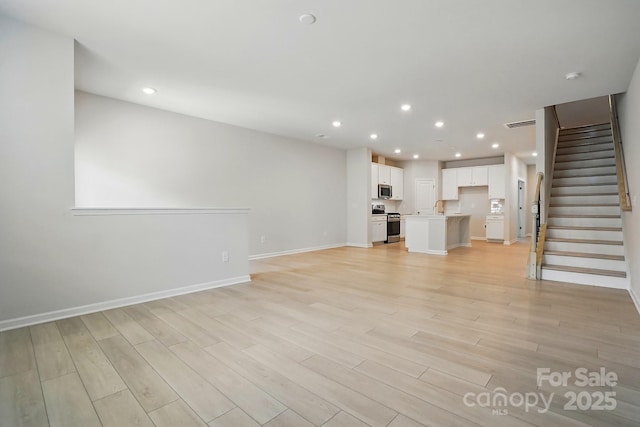 939 Cobbled Way, Fort Mill, SC 29715 - unfurnished living room with recessed lighting, stairway, light wood finished floors, and baseboards