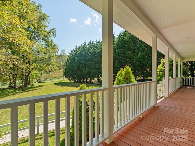 wooden deck featuring a yard and a porch