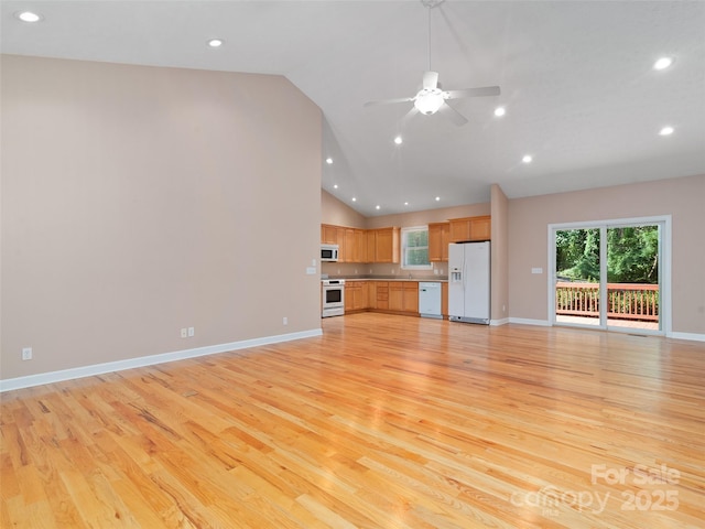 unfurnished living room featuring high vaulted ceiling, light hardwood / wood-style floors, and ceiling fan